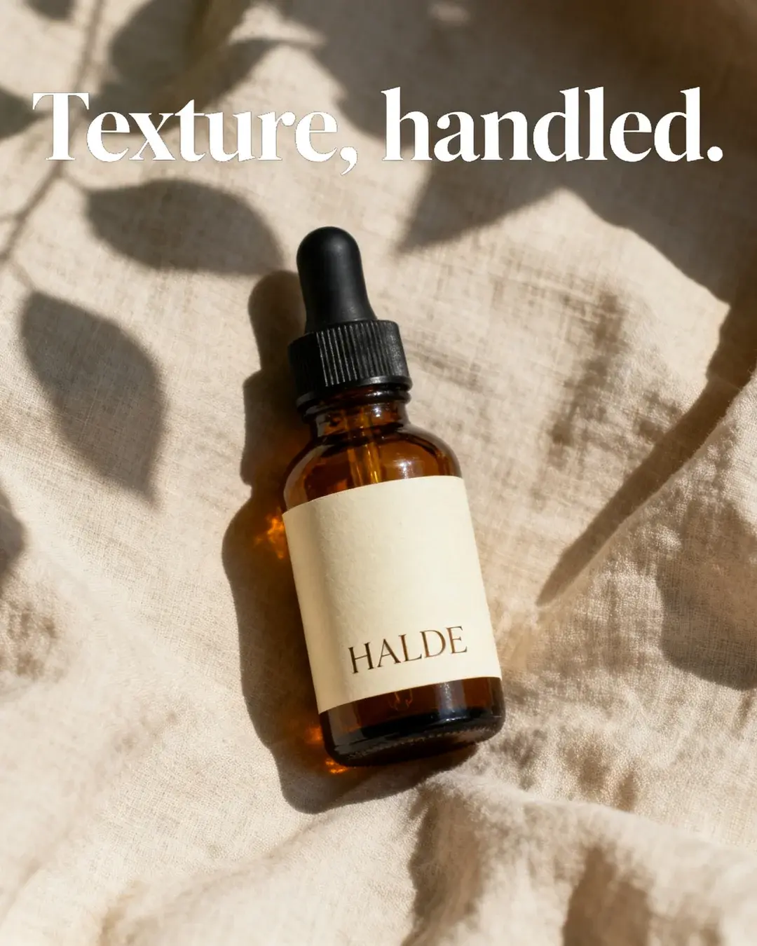 Halde concept: the amber bottle on linen under leaf shadows, headline “Texture, handled.”
