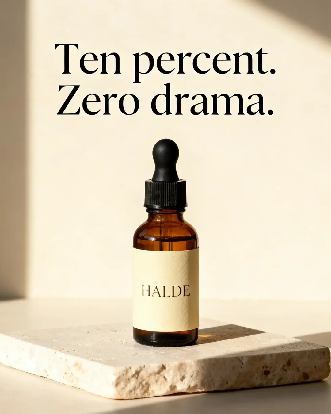 Halde concept: the amber bottle on travertine, headline “Ten percent. Zero drama.”